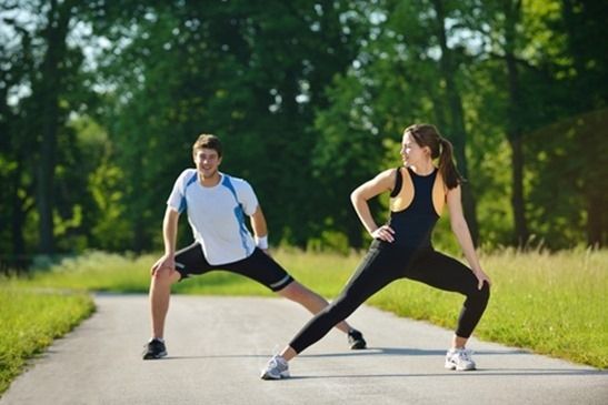 people doing stretching exercise  after jogging