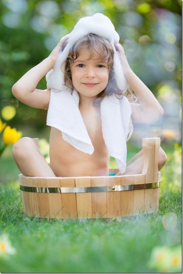 Child bathing outdoors in spring