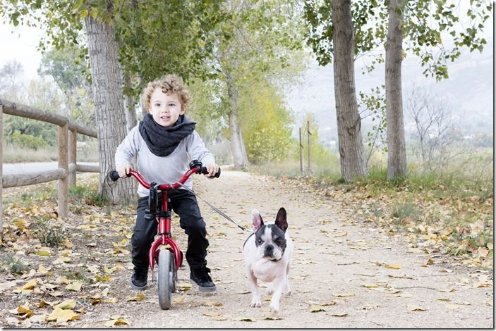 child riding bike with dog