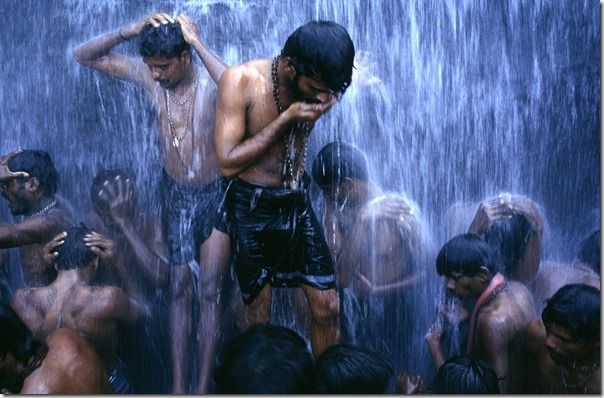 Followers of the Shiva sect of Hinduism (known as Shaivites or Shaivas) ritually bathe at a Hindu Bathing festival at Courtalam waterfall, Tamil Nadu, India. The town is dedicated to Lord Thirukutralanathar (Lord Siva). The Chittar River flows through the town into the main falls called the Peraruvi. 