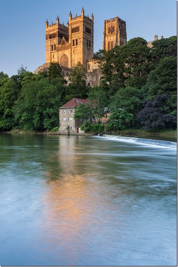 Durham Cathedral and the Museum of Archeology reflected in the water of the River Wear on a summer's evening