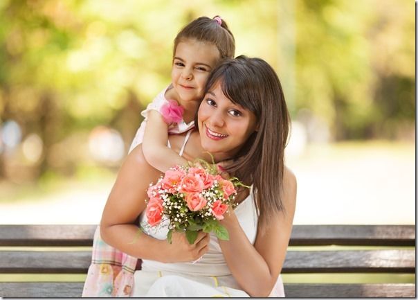 Mother and little daughter portrait in a park.