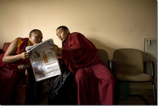 Buddhist monks reading a newspaper at the Vajra Vidya Institute for Buddhist studies in Sarnath, India