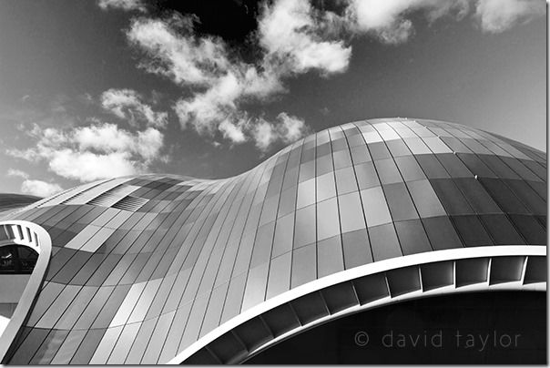 The glass roof of the Sage concert hall reflecting clouds in a blue sky, Gateshead, Tyne and Wear, England