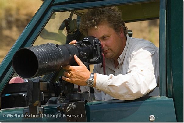 Wildlife photographer David Tipling photographing with a telephoto lens from safari vehicle in Masai Mara Kenya July 2005